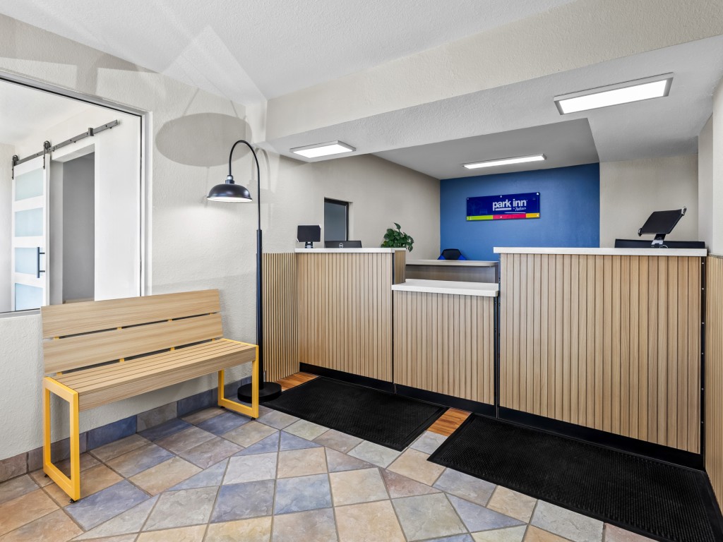 Lobby area of Park Inn Wells with modern decor and front desk.